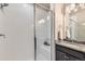 Close-up of tiled shower with glass enclosure and modern fixtures, showcasing cleanliness at 6153 N Ceylon St # 303, Denver, CO 80249