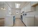 Well-lit kitchen features stylish white cabinets, neutral countertops, and modern fixtures, offering a clean aesthetic at 8329 W 90Th Pl, Westminster, CO 80021