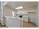 Bright kitchen with white cabinets, neutral countertops, and modern appliances, perfect for culinary enthusiasts at 8329 W 90Th Pl, Westminster, CO 80021