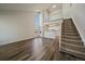 Bright living room features soaring ceilings, large windows, modern floors, and staircase access to the upper level at 8329 W 90Th Pl, Westminster, CO 80021
