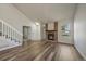 Inviting living room boasts updated floors, brick fireplace, and staircase, blending comfort with modern design at 8329 W 90Th Pl, Westminster, CO 80021