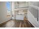 Bright living space with modern floors, large windows, and a view of the kitchen, creating a seamless flow at 8329 W 90Th Pl, Westminster, CO 80021
