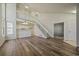 Bright, open-plan living area with modern floors, high ceilings, and staircase, leading to a kitchen and upper level at 8329 W 90Th Pl, Westminster, CO 80021