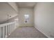 Carpeted loft area with vaulted ceilings and natural light from a window at 8329 W 90Th Pl, Westminster, CO 80021