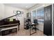 Bright home office with built-in shelving and a grand piano at 12039 Blackwell Way, Parker, CO 80138