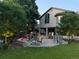 Cozy backyard with a fire pit seating area, patio with outdoor furniture, and well-lit landscaping at 5329 S Geneva St, Englewood, CO 80111