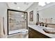 Bathroom with a glass shower, travertine walls, ceramic tile flooring, and modern vanity with towel rack at 5329 S Geneva St, Englewood, CO 80111