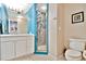 Bright bathroom featuring a white vanity, colorful tiled shower, and neutral walls at 5329 S Geneva St, Englewood, CO 80111