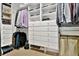 Walk-in closet with built-in shelves, drawers, and hanging rods for optimal organization at 5329 S Geneva St, Englewood, CO 80111