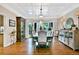 Elegant dining room featuring a bay window, hardwood floors, and decorative cabinet at 5329 S Geneva St, Englewood, CO 80111