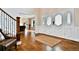 Welcoming foyer with hardwood floors, decorative front door, and view into the adjacent living space at 5329 S Geneva St, Englewood, CO 80111