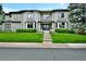 Stunning two-story home with manicured lawn, brick facade, bay windows, and arched entryway at 5329 S Geneva St, Englewood, CO 80111