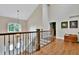 Upstairs hallway features hardwood flooring, a pendant light, and lots of natural light at 5329 S Geneva St, Englewood, CO 80111