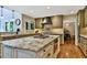 Bright kitchen boasts granite counters, custom cabinetry, a range hood, and a convenient center island at 5329 S Geneva St, Englewood, CO 80111