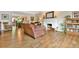 Cozy living room featuring a fireplace, hardwood floors, and seamless flow into the dining area at 5329 S Geneva St, Englewood, CO 80111