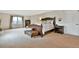Large bedroom with a wood bed frame, carpet flooring and natural light from the window at 5329 S Geneva St, Englewood, CO 80111