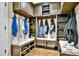 Mudroom with custom built-in organization, coat hooks, storage baskets, and shoe cubbies below cushioned seating at 5329 S Geneva St, Englewood, CO 80111