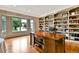 Spacious home office featuring custom built-in shelving, hardwood floors, and a large bay window at 5329 S Geneva St, Englewood, CO 80111