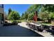 Relaxing patio with outdoor furniture, a dining table with umbrella, and a stone-planter retaining wall at 5329 S Geneva St, Englewood, CO 80111