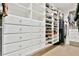 A walk-in closet featuring custom built-in shelving and ample drawer space for optimal organization and storage at 5329 S Geneva St, Englewood, CO 80111