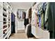 A walk-in closet featuring custom built-in shelving and hanging storage for optimal organization and storage at 5329 S Geneva St, Englewood, CO 80111