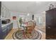 Cozy dining area with a round table, hardwood floors, and access to the outdoor living area at 2752 S Heather Gardens Way, Aurora, CO 80014