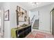 Inviting entryway with a staircase, accent rug, and console table displaying decorative art under modern lighting at 2752 S Heather Gardens Way, Aurora, CO 80014