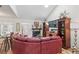 Comfortable living room with vaulted ceilings, fireplace, large sectional sofa, and hardwood floors at 2752 S Heather Gardens Way, Aurora, CO 80014