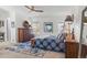 Bright bedroom with a ceiling fan, dresser, a blue patterned bedspread and ample natural light at 2752 S Heather Gardens Way, Aurora, CO 80014