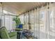 Relaxing sunroom with sheer curtains and comfortable seating, perfect for enjoying the view at 2752 S Heather Gardens Way, Aurora, CO 80014