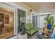 Cozy sunroom with plush seating, sheer curtains, and sliding glass doors, allowing seamless indoor-outdoor living at 2752 S Heather Gardens Way, Aurora, CO 80014