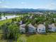Beautiful aerial view showcasing the community, green spaces, nearby lake, and the Rocky Mountains at 7400 W Grant Ranch Blvd # 19, Littleton, CO 80123