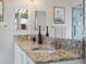 Bathroom featuring dual sinks with granite vanity and framed mirrors at 7400 W Grant Ranch Blvd # 19, Littleton, CO 80123
