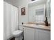 Standard bathroom featuring white toilet, sink, and a white shower curtain at 7400 W Grant Ranch Blvd # 19, Littleton, CO 80123