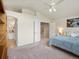 Carpeted bedroom with ceiling fan and views to the hall and kitchen at 7400 W Grant Ranch Blvd # 19, Littleton, CO 80123