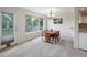 Bright dining room with large window, outdoor access, and granite countertop pass-through to kitchen at 7400 W Grant Ranch Blvd # 19, Littleton, CO 80123