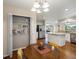 Open dining area, view into kitchen and pantry, featuring stylish lighting fixture and hardwood floors at 7400 W Grant Ranch Blvd # 19, Littleton, CO 80123