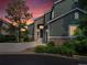Charming two-story home with stone accents, attached garage during sunset at 7400 W Grant Ranch Blvd # 19, Littleton, CO 80123