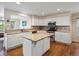 Well-equipped kitchen featuring white cabinets, granite countertops, island, and stainless steel appliances at 7400 W Grant Ranch Blvd # 19, Littleton, CO 80123