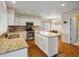 Bright kitchen features white cabinets, granite countertops, stainless steel appliances, and hardwood floors at 7400 W Grant Ranch Blvd # 19, Littleton, CO 80123