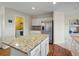 Bright kitchen with stainless steel appliances, granite countertops, hardwood floors, and center island at 7400 W Grant Ranch Blvd # 19, Littleton, CO 80123