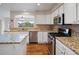 Well-appointed kitchen with stainless steel appliances, granite countertops, and stylish white cabinets at 7400 W Grant Ranch Blvd # 19, Littleton, CO 80123