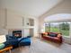 Bright living room featuring vaulted ceilings, a fireplace, and comfortable seating area with green views at 7400 W Grant Ranch Blvd # 19, Littleton, CO 80123