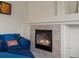 Cozy living room features a fireplace with tile surround and a comfortable blue sofa with throw pillows at 7400 W Grant Ranch Blvd # 19, Littleton, CO 80123