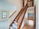 Open entryway with hardwood floors, staircase with wood railings, and ample natural light at 3873 W 98Th Ave, Westminster, CO 80031