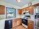 Kitchen with wood floors and cabinets, white countertops, and appliances, including a stainless-steel refrigerator at 3873 W 98Th Ave, Westminster, CO 80031