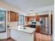 Spacious kitchen featuring wood cabinets, white countertops, stainless steel refrigerator, and ample natural light at 3873 W 98Th Ave, Westminster, CO 80031