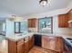 Bright kitchen boasts wood floors and cabinets, white countertops, and natural light from a window at 3873 W 98Th Ave, Westminster, CO 80031