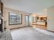 Spacious living room with fireplace, large window, a white door, and kitchen access at 3873 W 98Th Ave, Westminster, CO 80031