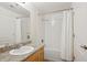 Well-lit bathroom featuring granite countertop and shower over tub at 8638 Gold Peak Dr # D, Highlands Ranch, CO 80130